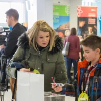 Des gens qui assistent à l'expo sciences 2018 dans le puits de hall du cégep